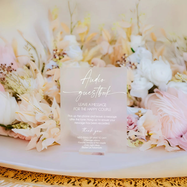 Size reference comparison of acrylic audio guestbook sign showing dimensions for wedding table placement