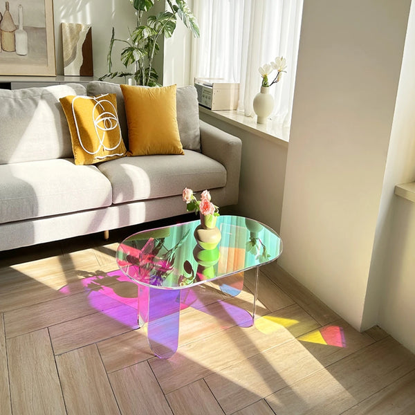 Iridescent acrylic side table used as modern bedroom nightstand with rainbow effect
