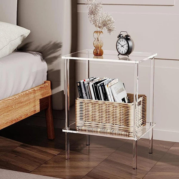 Modern clear acrylic side table used as a nightstand in a minimalist bedroom, with storage basket