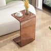Acrylic C-shape end table slid under sofa for drinks and books