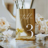 Weather-resistant acrylic table numbers displayed at outdoor garden wedding reception venue