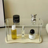 Acrylic perfume organizer placed on bathroom counter