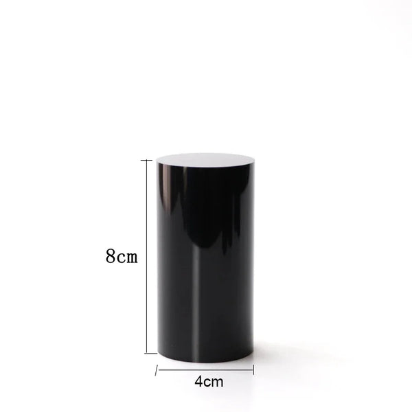 Cosmetics products arranged on various heights of black acrylic display risers