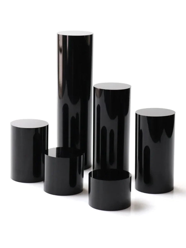 Diamond rings displayed on black acrylic cylinder stands for jewelry retail showcase