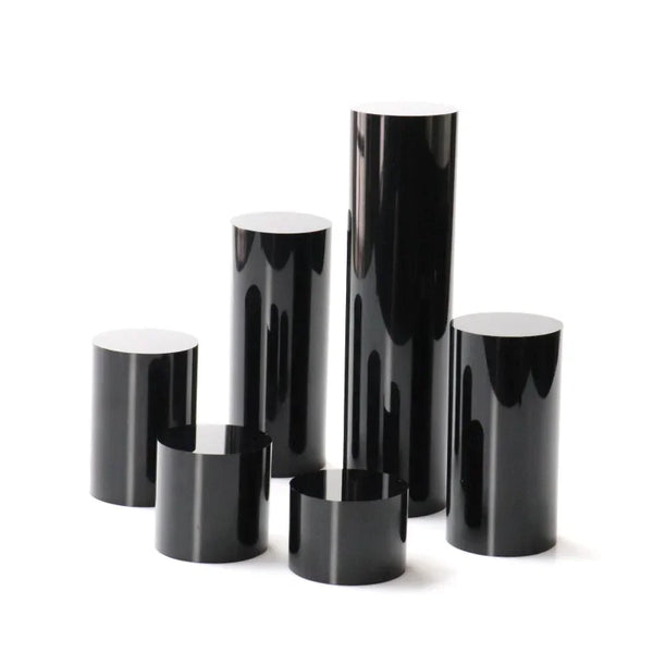 Wedding ring set displayed on black acrylic cylinder stands