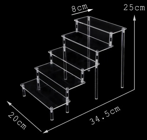 Handmade clay figurines displayed on clear acrylic tiered organizer