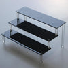 Front view of black acrylic display stand with 5 tiers for makeup and cupcakes