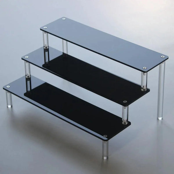 Front view of black acrylic display stand with 5 tiers for makeup and cupcakes