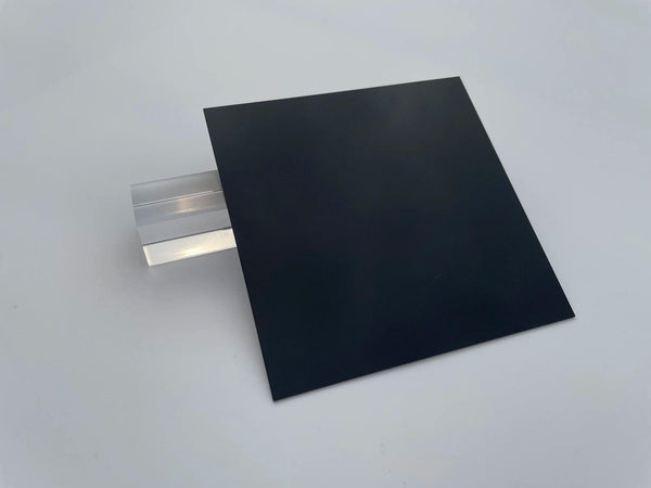 Stacked square black acrylic panels in different sizes