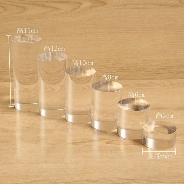 Gold bracelet elevated on acrylic display cylinder for retail showcase