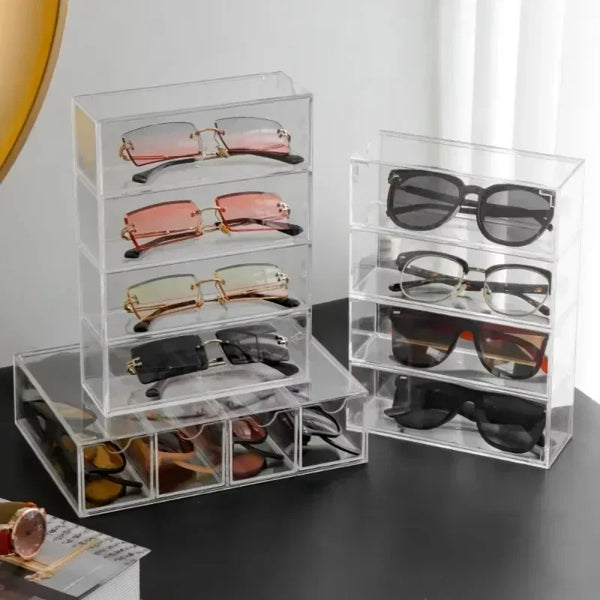 Clear acrylic drawer organizer displaying multiple pairs of sunglasses and eyeglasses
