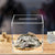 Clear acrylic money saving box with transparent walls and coin slot - front view