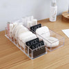 Clear acrylic cosmetic organizer on vanity table with skincare products