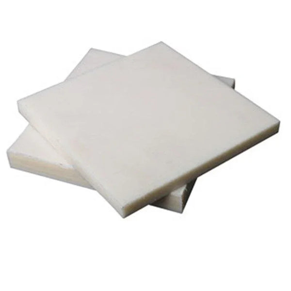 Custom cut white nylon boards stacked in various sizes