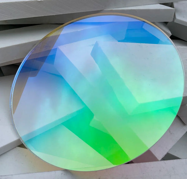 Rainbow acrylic circle displaying blue, green, and purple dichroic color shift
