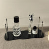 3-tier acrylic shelf on bedroom dresser with perfume collection