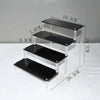 Unboxed acrylic display stand packed flat for shipping