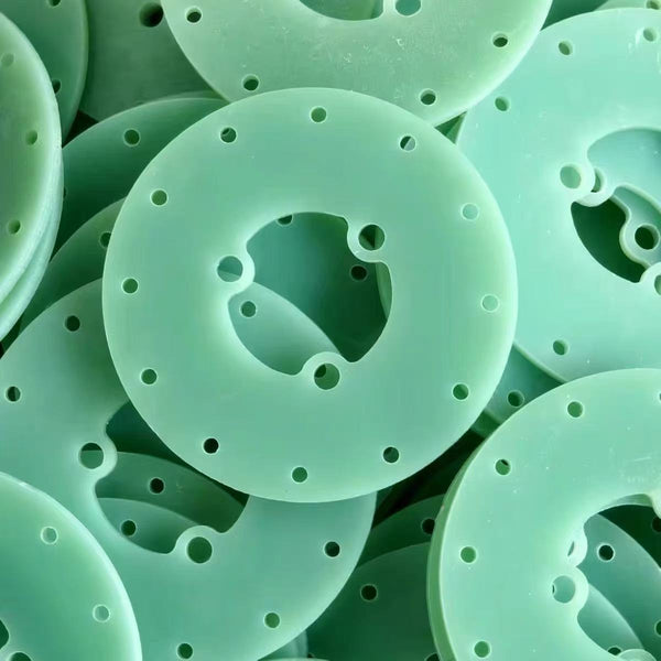 Close-up detail of green FR4 epoxy glass fiber sheet surface texture for PCB applications