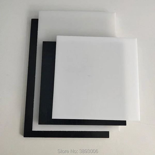 Black and white HDPE sheet being machined on a CNC router