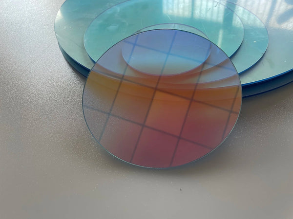 Retail shelf display enhanced with iridescent acrylic circle product holders