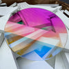Transparent iridescent acrylic circle showing clear base with dichroic coating