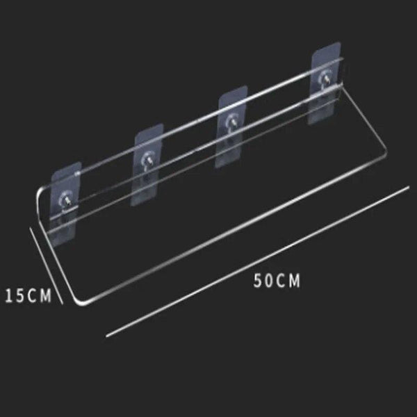 Makeup palettes and bottles organized on floating acrylic shelf