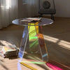 Modern iridescent acrylic side table used in contemporary living room interior design setting