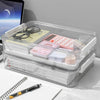 Modern office workspace organization using multiple clear acrylic storage boxes