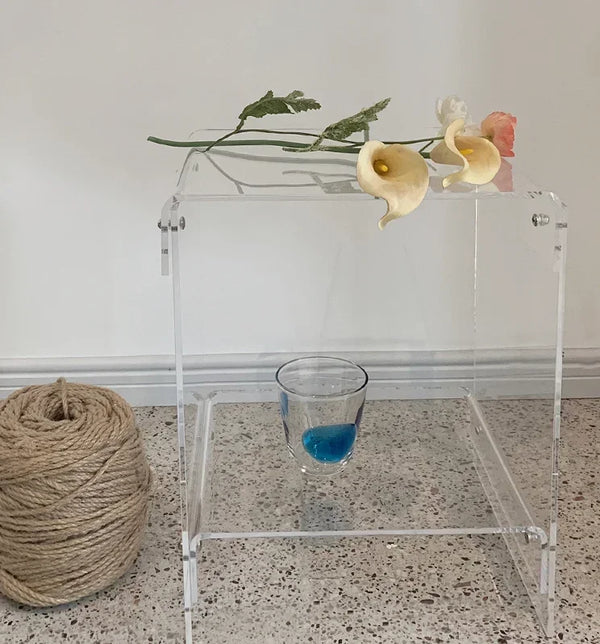 Vibrant orange acrylic coffee table in modern home setting