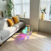 Side view of oval acrylic coffee table with four clear legs and transparent design