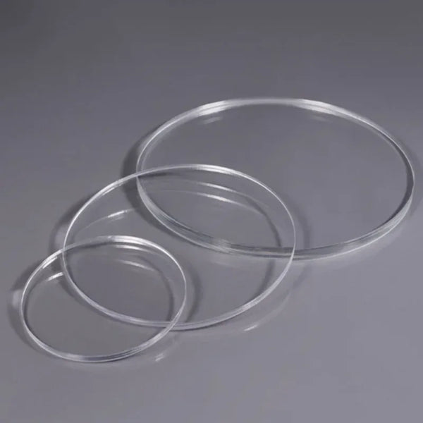 Polished smooth edge finish on clear acrylic disc showing professional quality