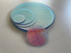 Iridescent acrylic circle with protective film on both sides before removal