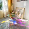 Close-up of rainbow iridescent effect on clear acrylic coffee table surface showing color spectrum