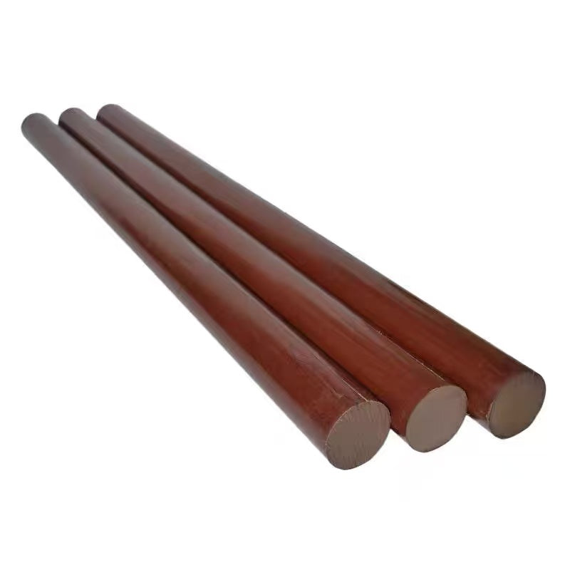 Close-up of the surface texture of phenolic Bakelite insulation rod showing cotton-reinforced layers