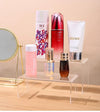 Elegant acrylic display riser showcasing perfume bottles at different heights