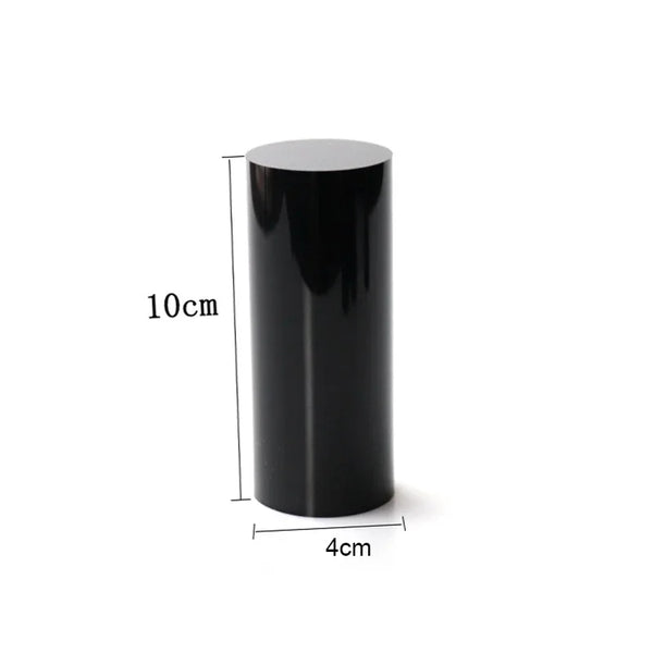 Watch displayed on black acrylic cylinder base for retail presentation