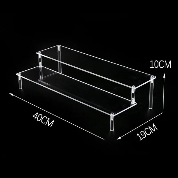 Decorative candles arranged on transparent acrylic tiered display