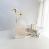 Clear acrylic vase variant G styled in modern cafe environment