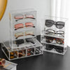 Clear acrylic drawer organizer displaying multiple pairs of sunglasses and eyeglasses
