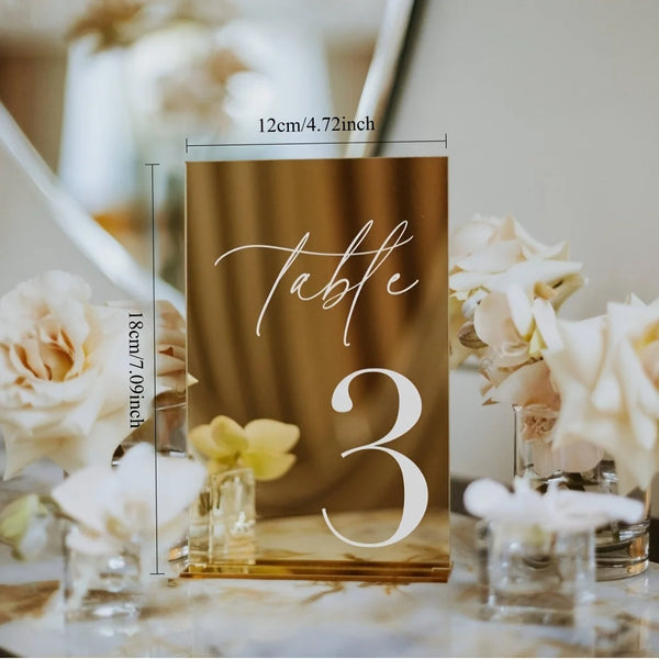 Close-up of laser cut acrylic table number showing gold UV printed lettering and polished edge finish