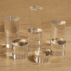 Perfume bottles and cosmetics displayed on acrylic cylinder risers