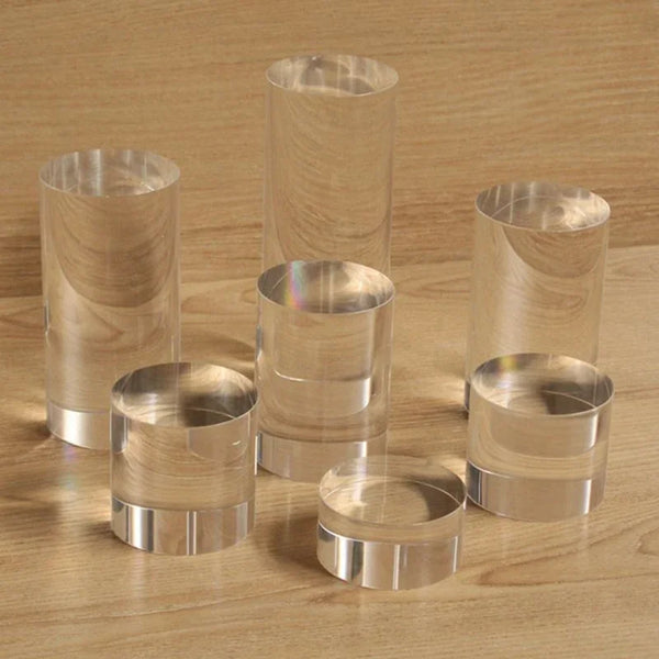 Perfume bottles and cosmetics displayed on acrylic cylinder risers