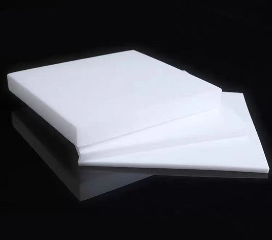 Custom-cut PTFE sheet sample with drilled holes and smooth finish