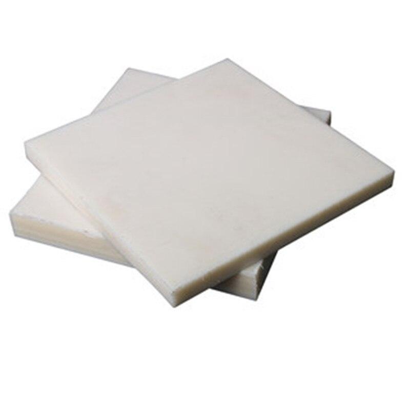 Custom cut white nylon boards stacked in various sizes