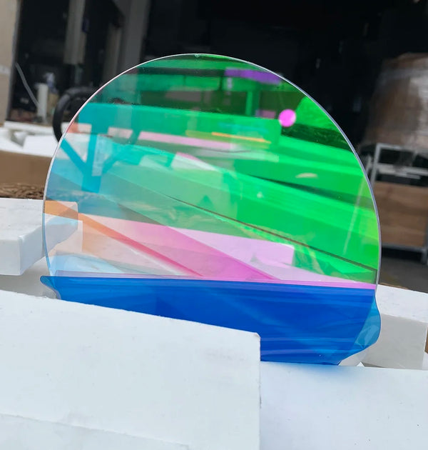 Custom laser-cut dichroic acrylic signage on commercial storefront with rainbow effect