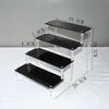 Unboxed acrylic display stand packed flat for shipping
