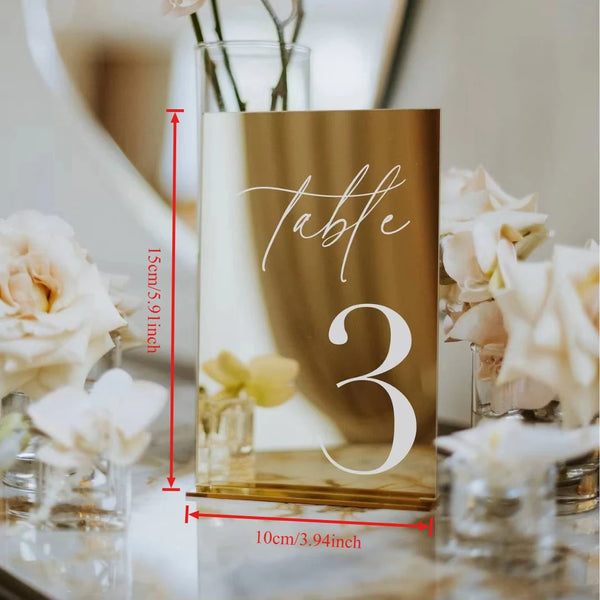 Multiple gold acrylic table numbers arranged showing consistent quality and elegant design