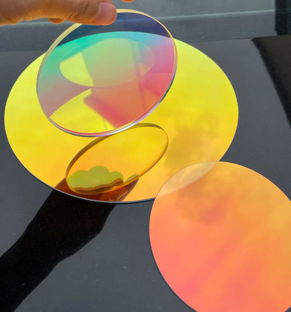 Closeup of laser-cut polished edge on 300mm iridescent PMMA circle showing precision finish