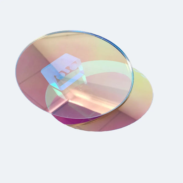 Iridescent acrylic circle under natural daylight showing full rainbow spectrum