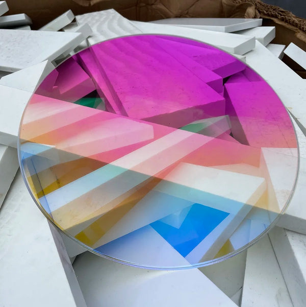 Transparent iridescent acrylic circle showing clear base with dichroic coating